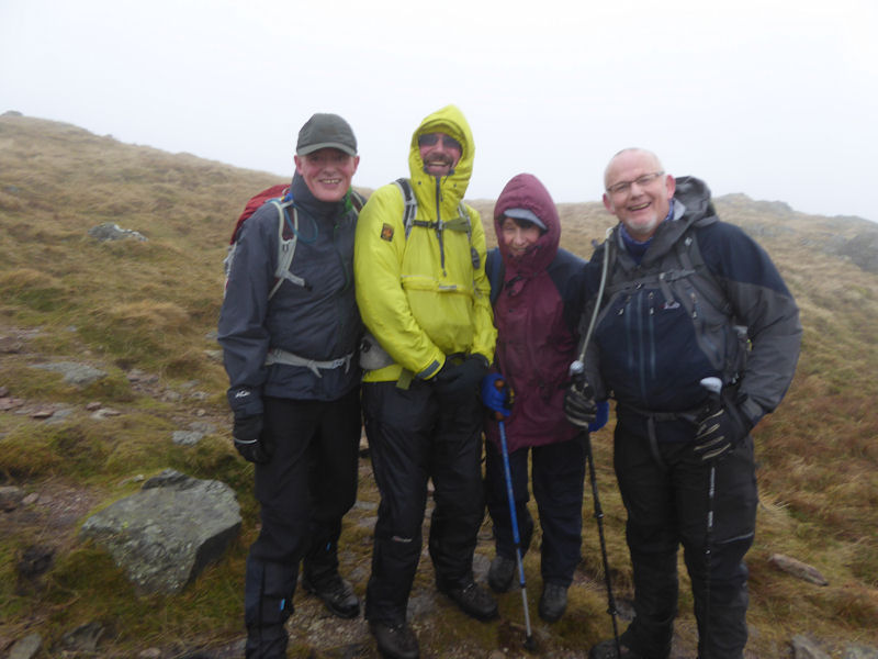 Ed, Duncan, Judy and Paul S on a windy Place Fell. Photo by Mike Goodyer